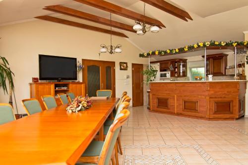 a dining room with a large wooden table and chairs at Vila Valča in Valča