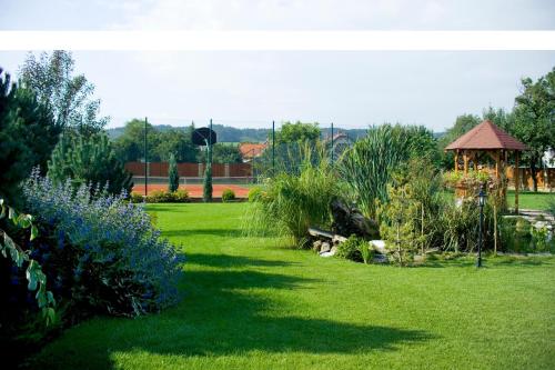 a garden with a gazebo and some bushes at Vila Valča in Valča