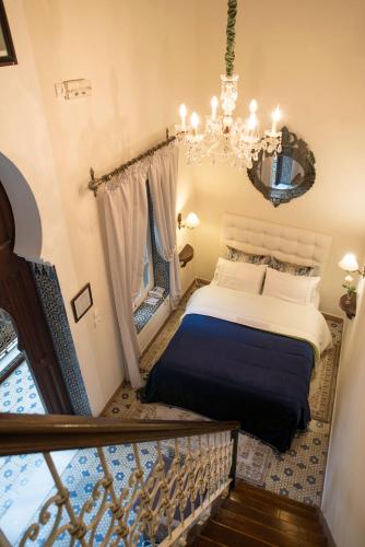 a bedroom with a bed and a chandelier at El Reducto in Tetouan