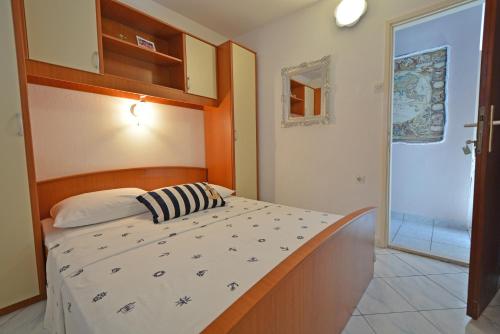 a bedroom with a bed and a sliding glass door at Apartments Residence Sunce Supetar - cozy base to stay and explore Dalmatian archipelago in Supetar