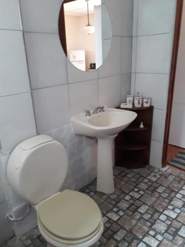 a bathroom with a white toilet and a sink at Alquiler Monoambiente in Reyes