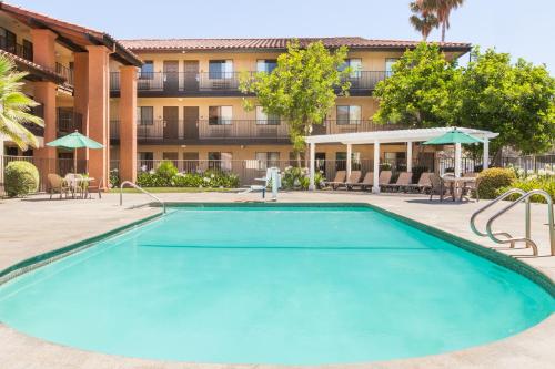 a large swimming pool in front of a building at Days Inn by Wyndham San Jose Airport in Milpitas