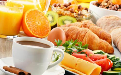 a tray of breakfast foods and a cup of coffee at Egrypos Hotel in Petrití