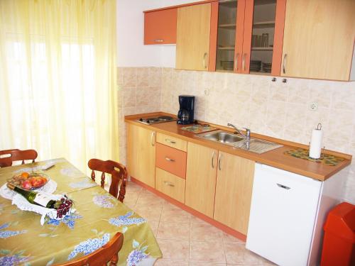 a kitchen with a table and a sink at Apartment Bilac in Vodice