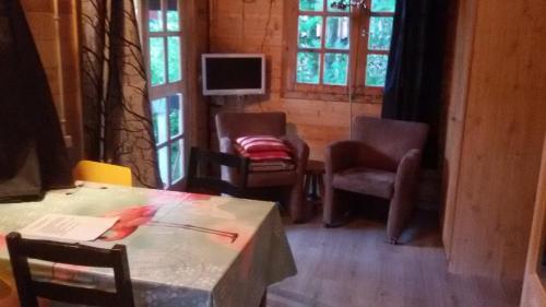 salon ze stołem, krzesłami i oknami w obiekcie Blokhut Meerland w mieście Oostwold