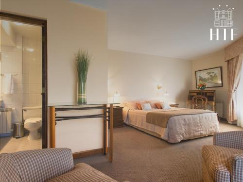 A bed or beds in a room at Hotel Tierra Del Fuego