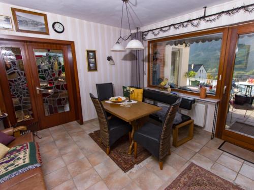a kitchen and dining room with a table and chairs at Bed & Breakfast Sandra Müller in Burg an der Mosel