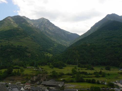 a view of a mountain valley with a town and houses at Gauach in Bossost