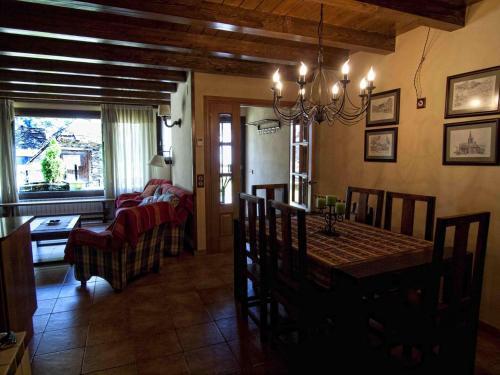 a dining room and living room with a dining table at Gauach in Bossost