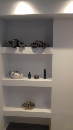 a shelf with a bunch of items on it at Milva Apartments in Kos Town