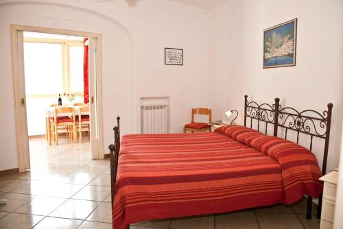 a bedroom with a large bed with a red blanket at La Casarella Apartment Positano in Positano