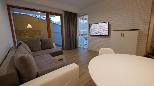 a living room with a couch and a table at Apartamenty Willowa in Szczyrk