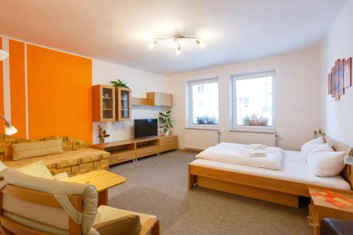 a large room with two beds and a living room at Pension Kraus in Litomyšl
