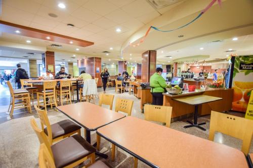 a restaurant with tables and chairs and people in it at United College in Waterloo