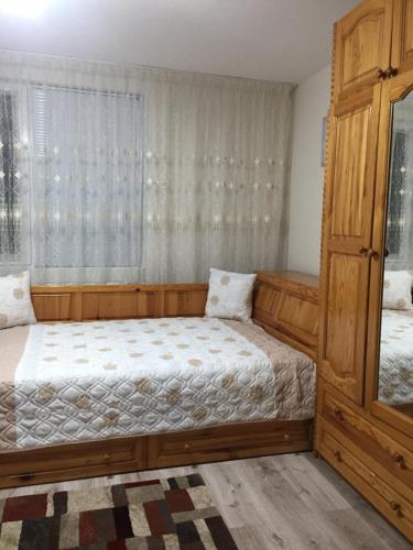 a bedroom with two beds and a window at Elenite Guesthouse in Gotse Delchev