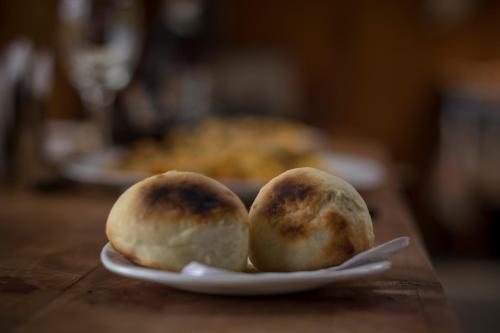 two buns sitting on a plate on a table at Estancia Dos Elianas in Torres del Paine