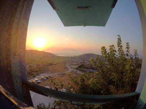 a view of the sunset from a wine barrel at Dimitri Ada Evi & Restaurant in Gokceada Town
