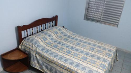 Una cama con edredón en un dormitorio en Flat Condominio Gaivotas Alcobaça BA a 100 metros do mar en Alcobaça