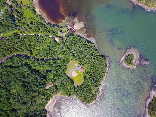 an overhead view of the ocean with trees and water at Les 2 Iles in La Malbaie