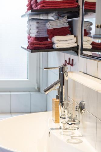 a bathroom sink with a faucet and some towels at Ferienwohnung "schöner Wohnen" in Westerstede