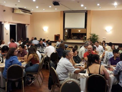 a group of people sitting at tables in a room at Quintana Hotel in San Luis