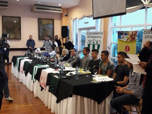 a group of people sitting at long tables in a room at Quintana Hotel in San Luis