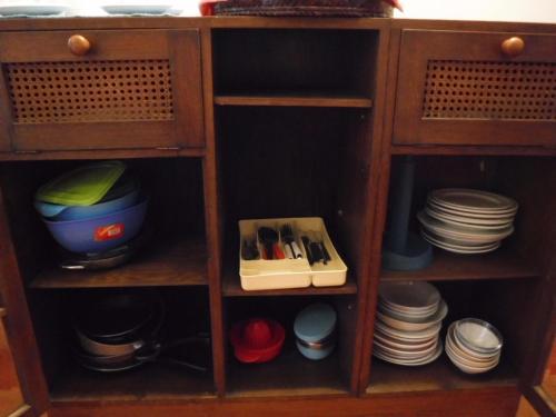 a wooden cabinet with dishes and plates in it at Stasion Di Pueste in Nogaredo Al Torre