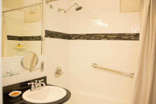 a bathroom with a shower, sink, and toilet at Chancellor Hotel on Union Square in San Francisco
