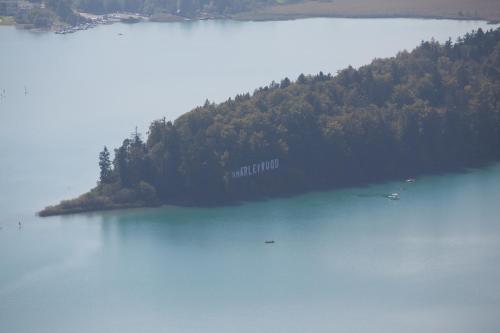 an island in the middle of a large body of water at Ferienhäuser Glück Auf, Sauna, Hottubs in Arnoldstein