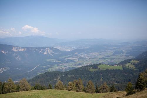 a view of a valley from a mountain at Ferienhäuser Glück Auf, Sauna, Hottubs in Arnoldstein
