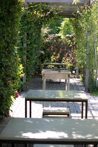a picnic table and a bench in a garden at B&B a Ca' Minore Franciacorta in Passirano