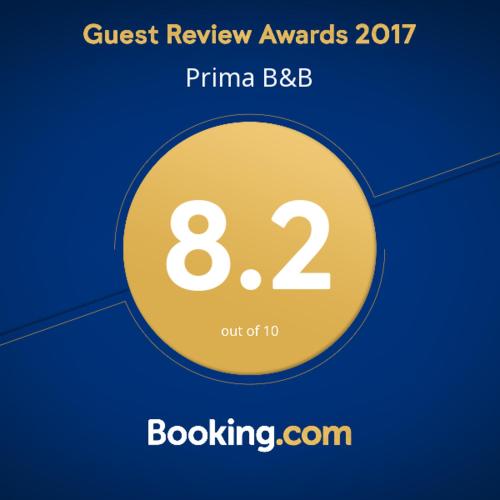a yellow circle with the words quest review awards on it at Prima B&B Hostel in Sandakan