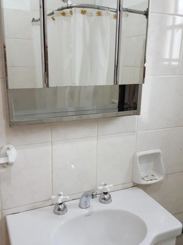 a bathroom with a sink and a mirror at Cabañas Años Verdes in Sarmiento