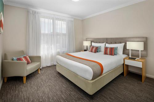 A bed or beds in a room at Quest Wollongong