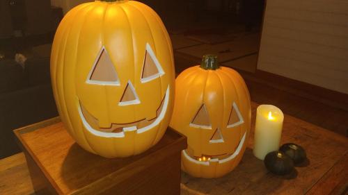 two pumpkins sitting on a table next to a candle at Oyado Matsubaya in Minakami