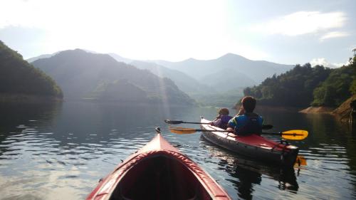 a woman and child in a kayak on a lake at Oyado Matsubaya in Minakami