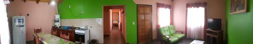 a living room with green and pink walls at Cabañas Años Verdes in Sarmiento