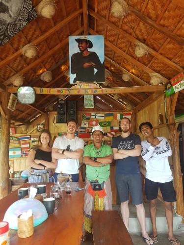 a group of people standing in front of a table at Black Lava Hostel and Lodge in Kintamani