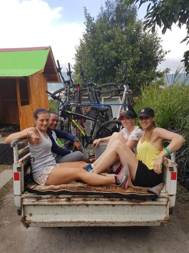 a group of women sitting in the back of a truck at Black Lava Hostel and Lodge in Kintamani
