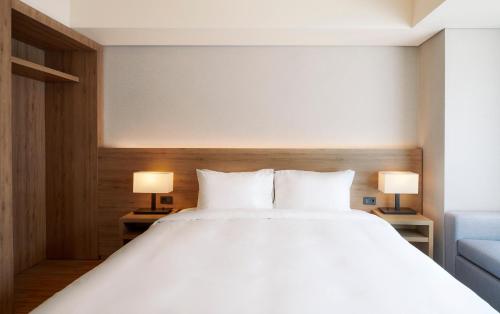 Ένα ή περισσότερα κρεβάτια σε δωμάτιο στο PARK ROCHE Resort & Wellness