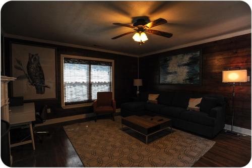 a living room with a couch and a ceiling fan at The Coyle Cabin - Close to Downtown, Stadiums, U of H, Med Center in Houston