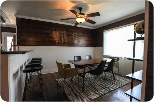 a dining room with a ceiling fan and a table and chairs at The Coyle Cabin - Close to Downtown, Stadiums, U of H, Med Center in Houston