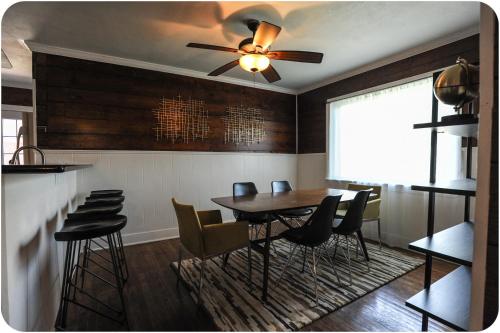 a dining room with a ceiling fan and a table and chairs at The Coyle Cabin - Close to Downtown, Stadiums, U of H, Med Center in Houston