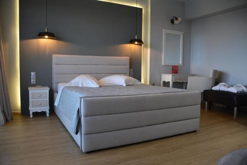 a bedroom with a large white bed in a room at Scorpios Sea Side Hotel in Piraeus