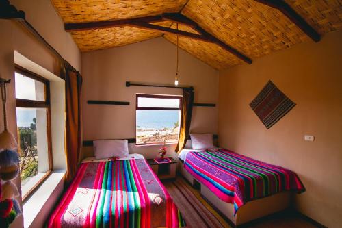 Postel nebo postele na pokoji v ubytování LUQUINA NATURAL Lodge