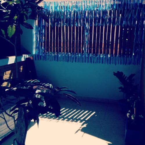 a fence in a room with a plant at Casa Blanka 2010 - Eco Surf Guest House in Itacaré