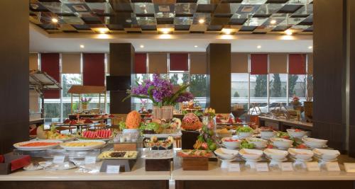 a buffet line with many different types of food at Atria Hotel Magelang in Magelang
