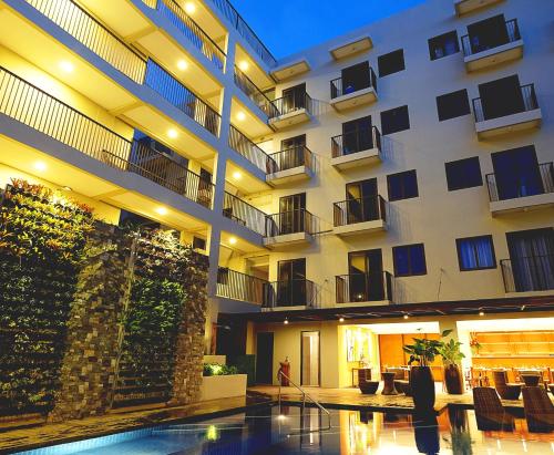 a large building with a swimming pool in front of it at Altabriza Resort Boracay in Boracay