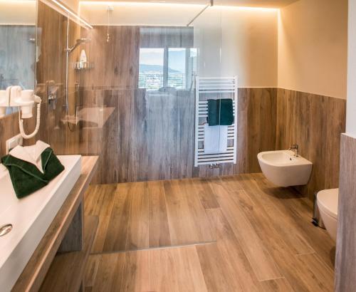 a bathroom with a shower and a sink and a toilet at Residence Prunarhof in Caldaro
