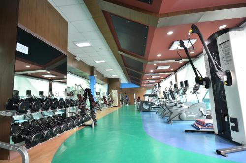 a gym with lots of treadmills and machines at Trace Suites by SMS Hospitality in Los Baños
